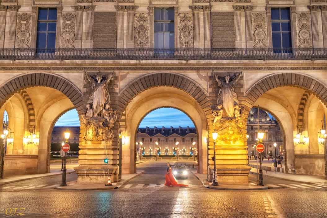 Illuminated arches of the Louvre courtyard at night