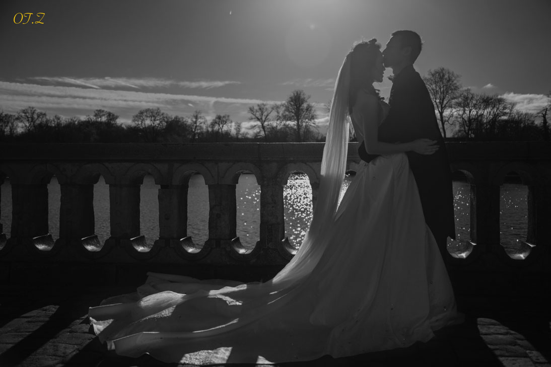 Silhouette of a bride and groom kissing at sunset